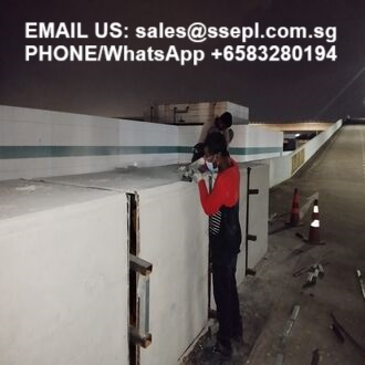 Two workers on a rooftop wall at night, with overlaid contact info: email sales@ssepl.com.sg and WhatsApp +65 8328 0194