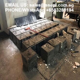 Reinforced concrete block base with a steel rebar grid in a workshop; contact text overlay on top corner.