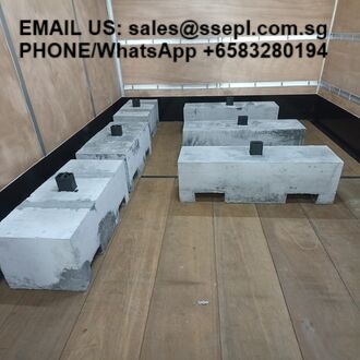 Concrete blocks arranged in two rows on a wooden truck bed, with "Email us" and a WhatsApp number overlaid at the top for contact.