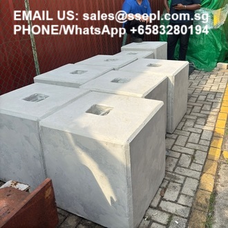 Row of hollow, square concrete blocks with center openings on a paved surface; overlay text shows contact email and phone number.