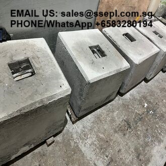 Row of concrete blocks with top slots on a dusty surface; black text overlays provide contact email and WhatsApp number.